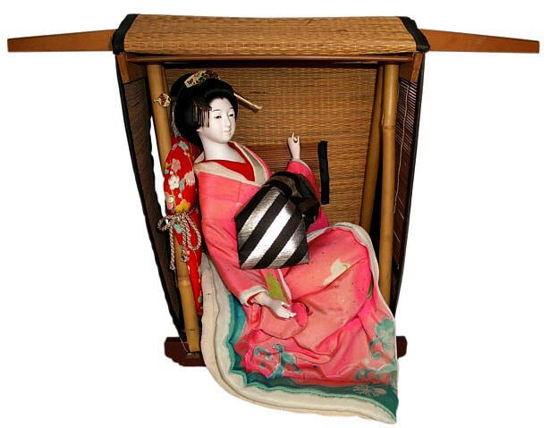 japanese antique geisha doll sitting in traditional ancient taxi - kago