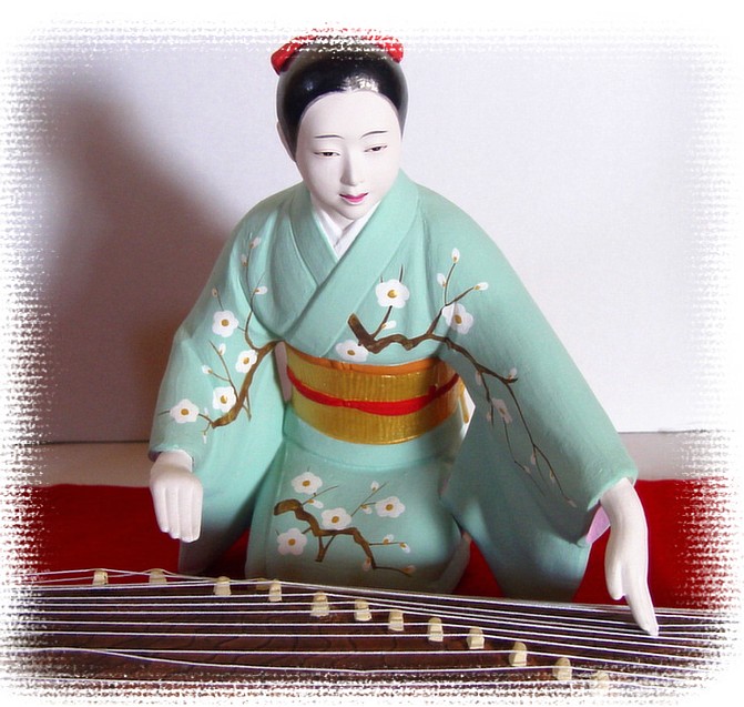 japanese hakata figurine of a woman playng koto, 1950's