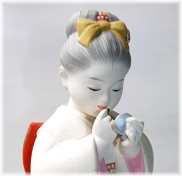 japanese hakata clay doll od a girl with lipstick and mirror